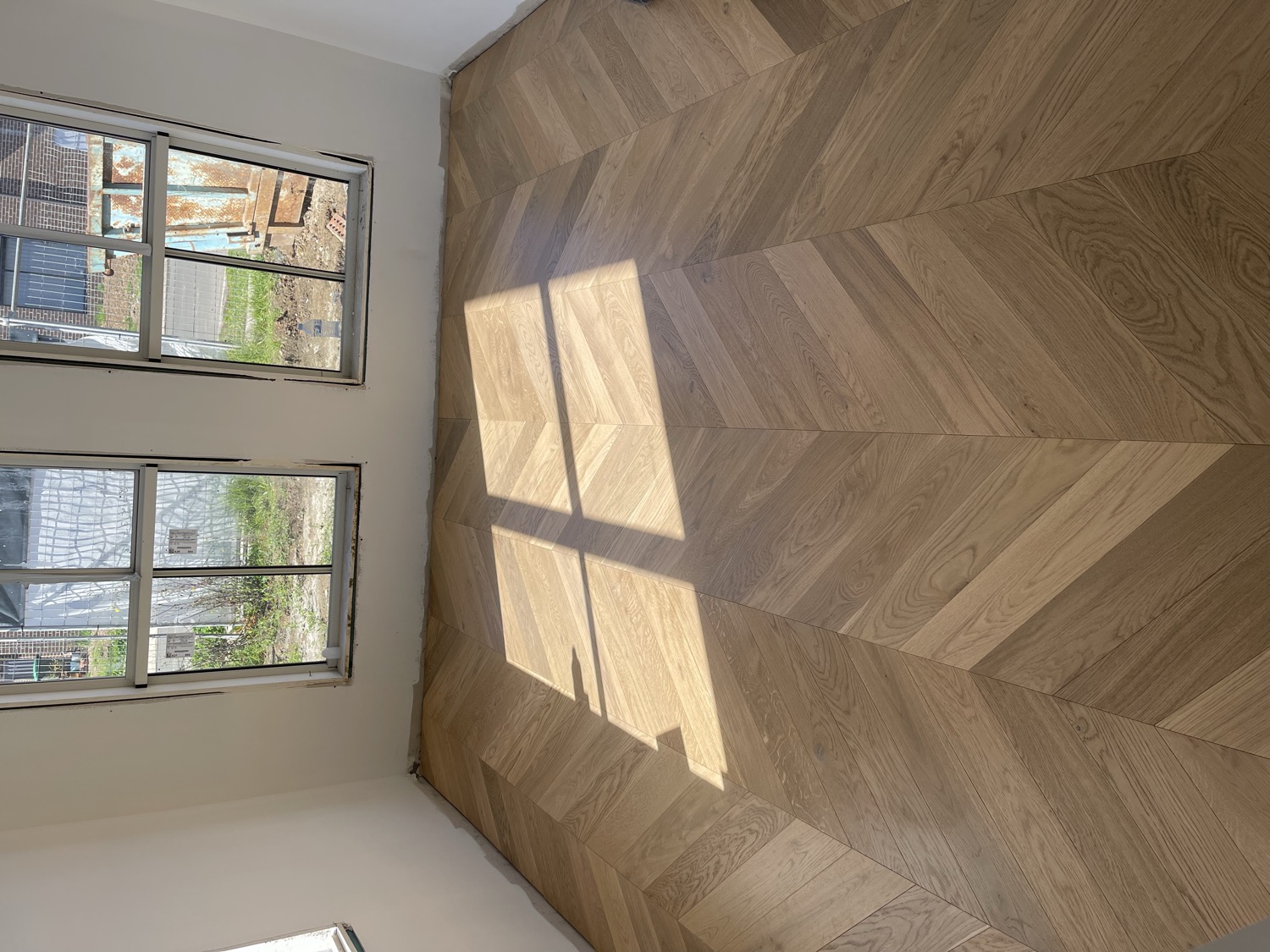 Finished engineered chevron flooring in a sunlit Sydney room