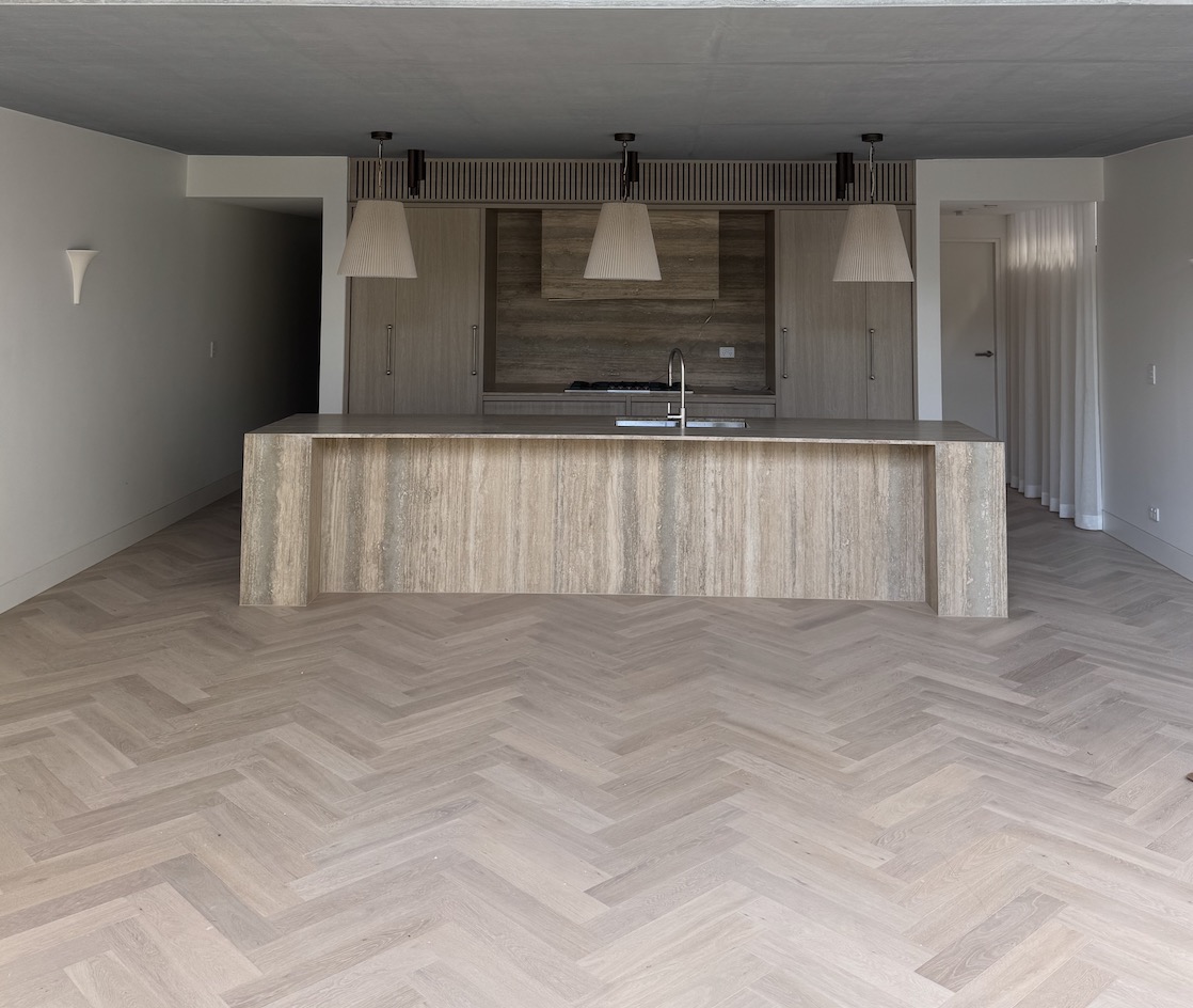 Finished engineered herringbone timber flooring in a Sydney kitchen and living area
