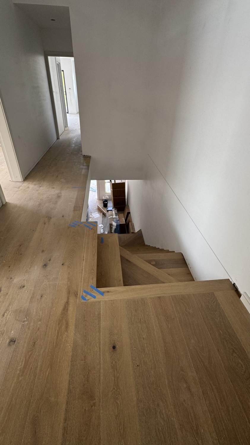 Finished engineered straight plank direct stick flooring and stair in Sydney