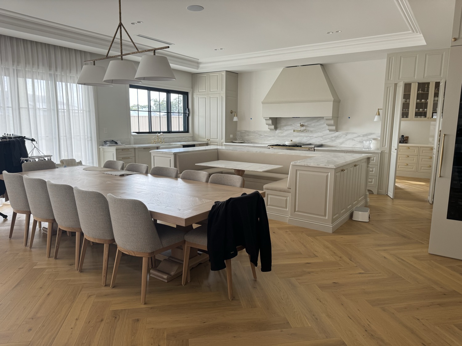 Finished wide and long plank engineered herringbone flooring in a Sydney kitchen and dining area